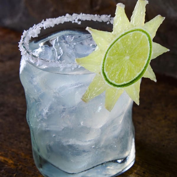 Mariano's Restaurants margarita with a salted rim, ice, and a sun-shaped lime garnish.
