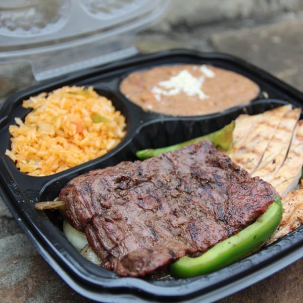 Mariano's Mexican takeout container with grilled steak, chicken, rice, and refried beans.
