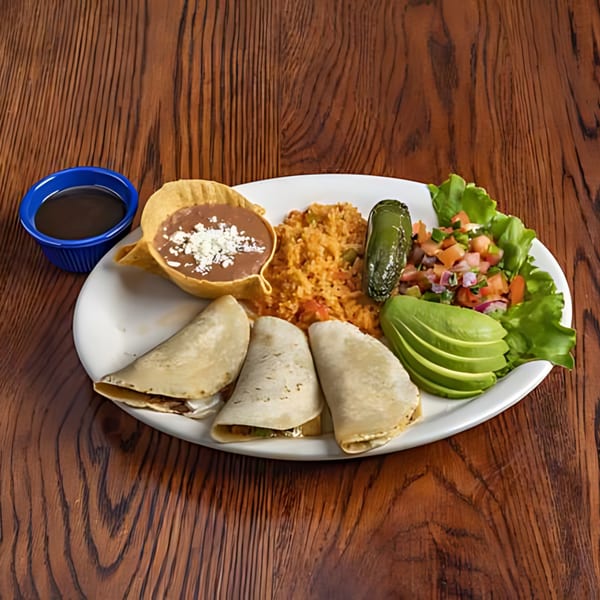 Mariano's Mexican plate with tacos, rice, refried beans, avocado, salsa, and a grilled jalapeño.