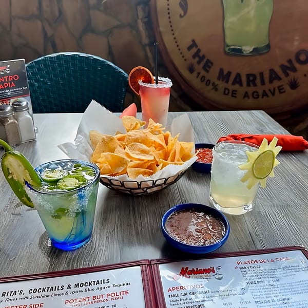 Mariano's table with chips, salsa, queso, and three margaritas, including a jalapeño margarita.